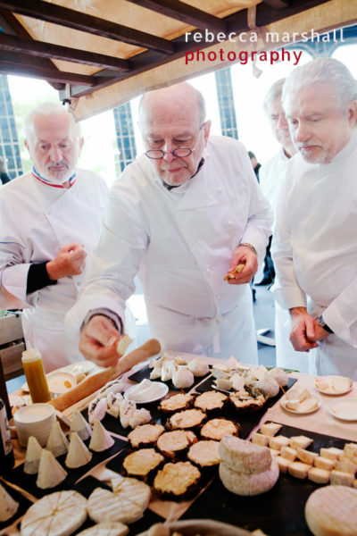 3 chefs, Yves Thuries, Michel Trama and Alain DuTournier, taste cheeses at a market stall