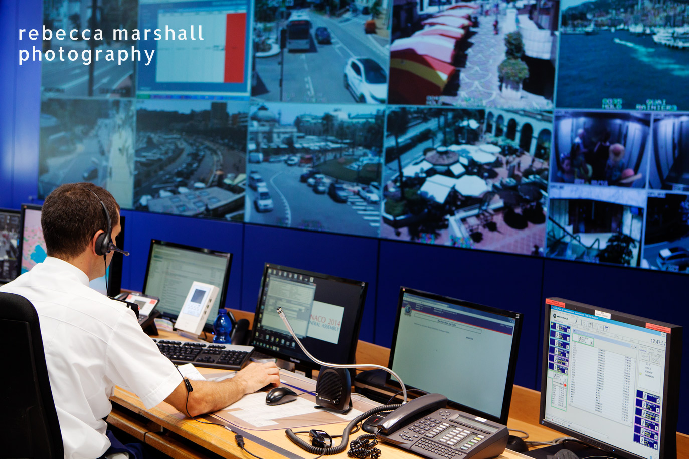 Photograph of the wall of screens displaying feed from security cameras at the central operations office of the Monaco Police