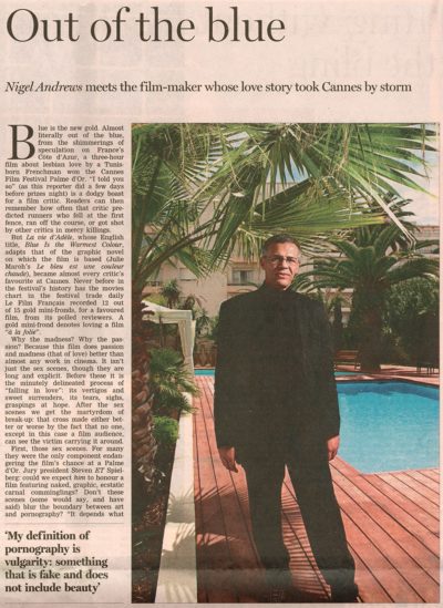 Tear sheet from newspaper showing portrait of Abdellatif Kechiche standing by the pool