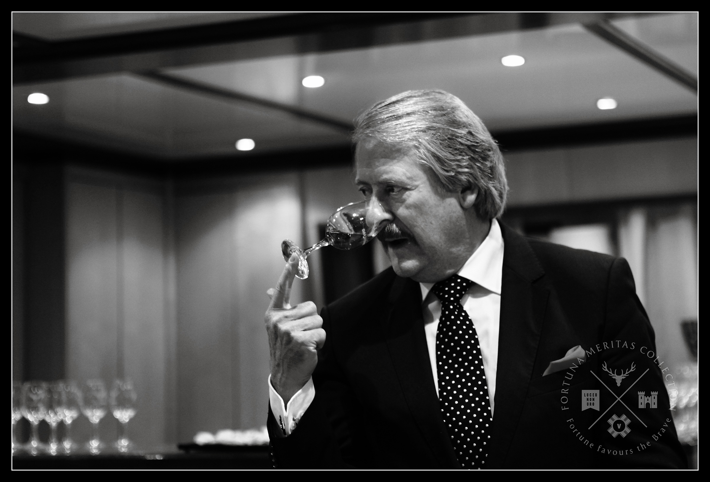 Black and white photograph of Master Whisky Blender Richard Paterson smelling a whisky