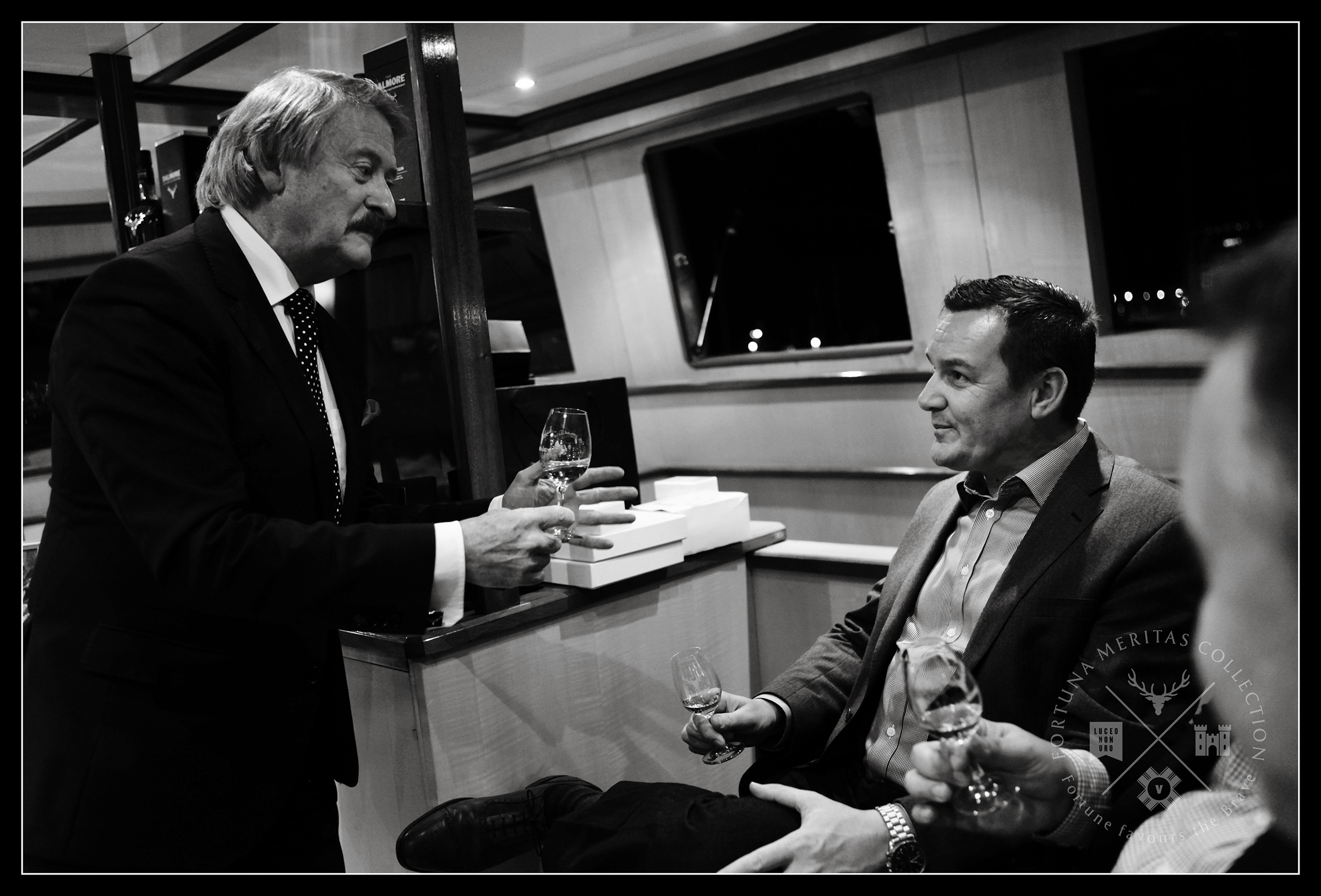 Two men tasting whisky in the saloon of a super yacht