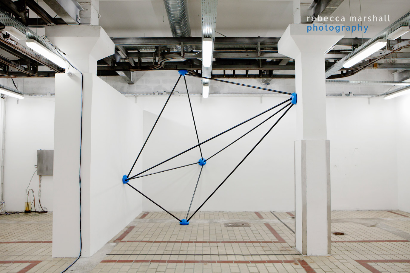 Photograph of a modern art installation in a white industrial gallery space
