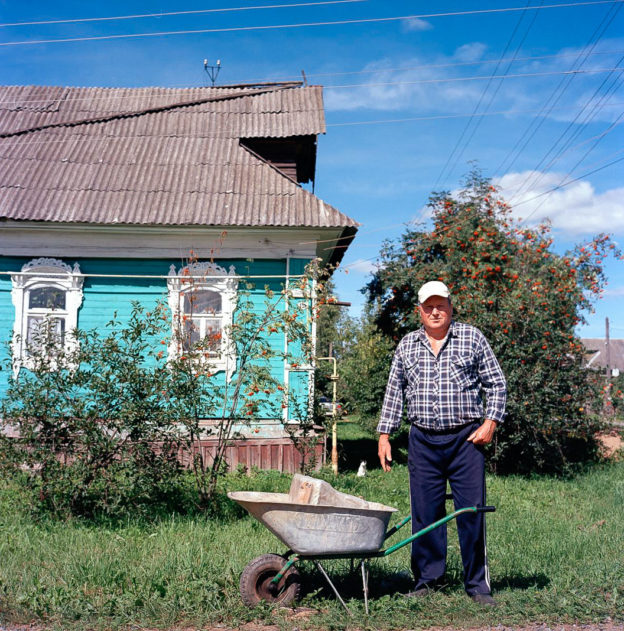 Man in his garden with a wheelbarrow