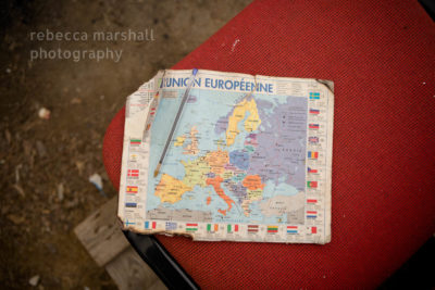 Detail photograph of a well-worn map of the EU on a red chair