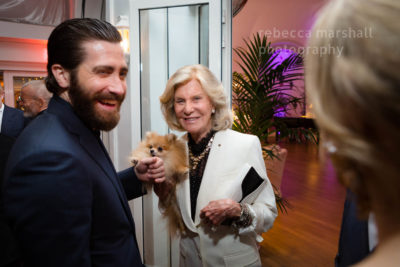 Photograph of Jake Gyllenhaal and countess Marina Cicogna with her dog at a party