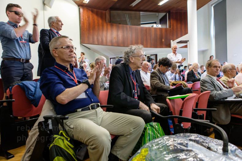 Photo of delegates applauding a speaker at a conference