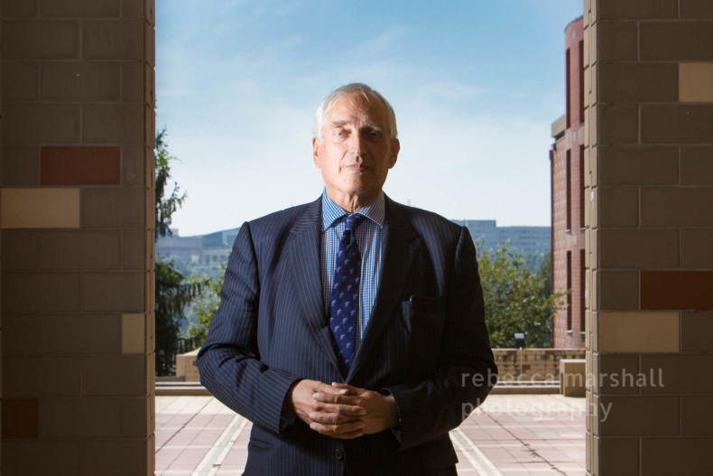 Portrait of Christopher Monckton standing in a university yard in front of a blue sky