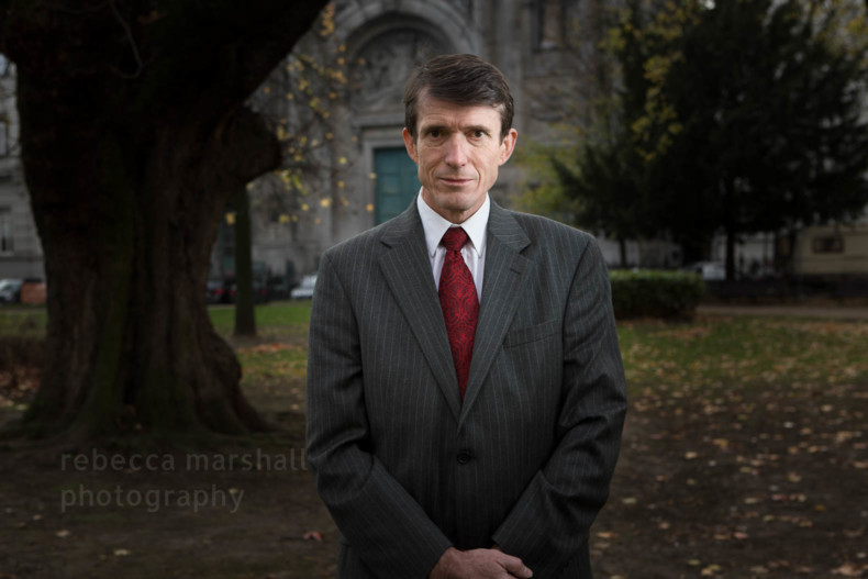 Portrait of Brian Ricketts standing in a dark park