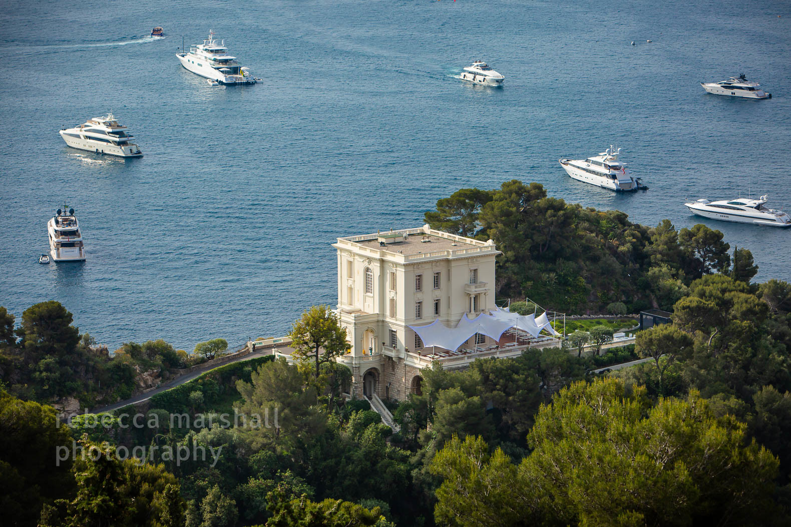 Photograph of Villa La Vigie from above, with yachts in the background