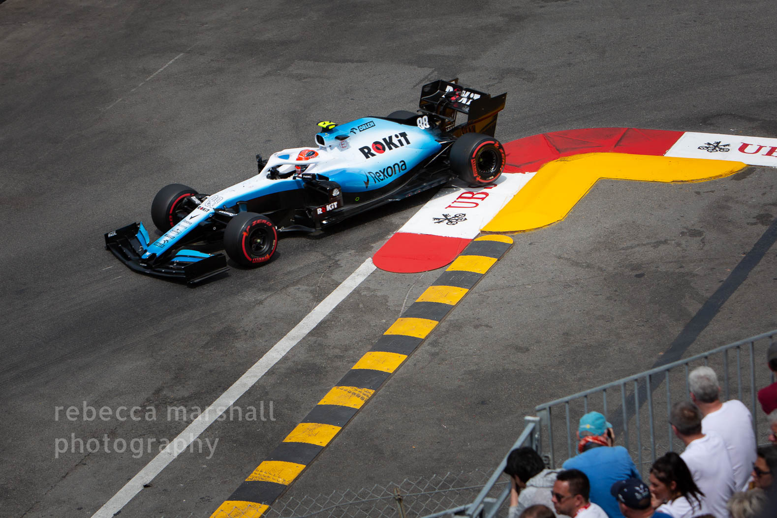 Photograph of blue Formula One racing car cornering on circuit