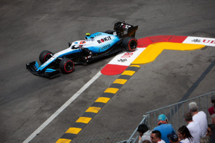 Photograph of blue Formula One racing car cornering on circuit