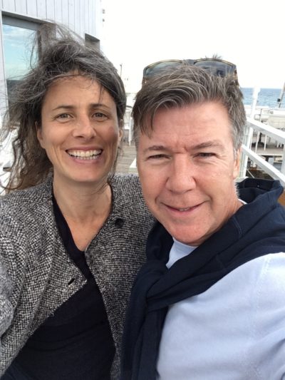 iPhone photograph of man and woman smiling in the wind