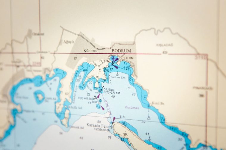 Close-up photograph of nautical chart showing the coastal town of Bodrum in focus