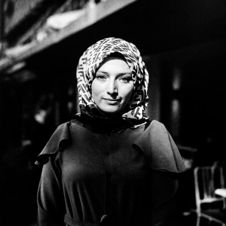 Black and white portrait of young woman with headscarf