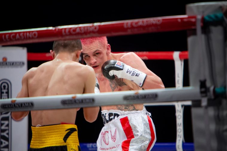 2 boxers in action in the ring