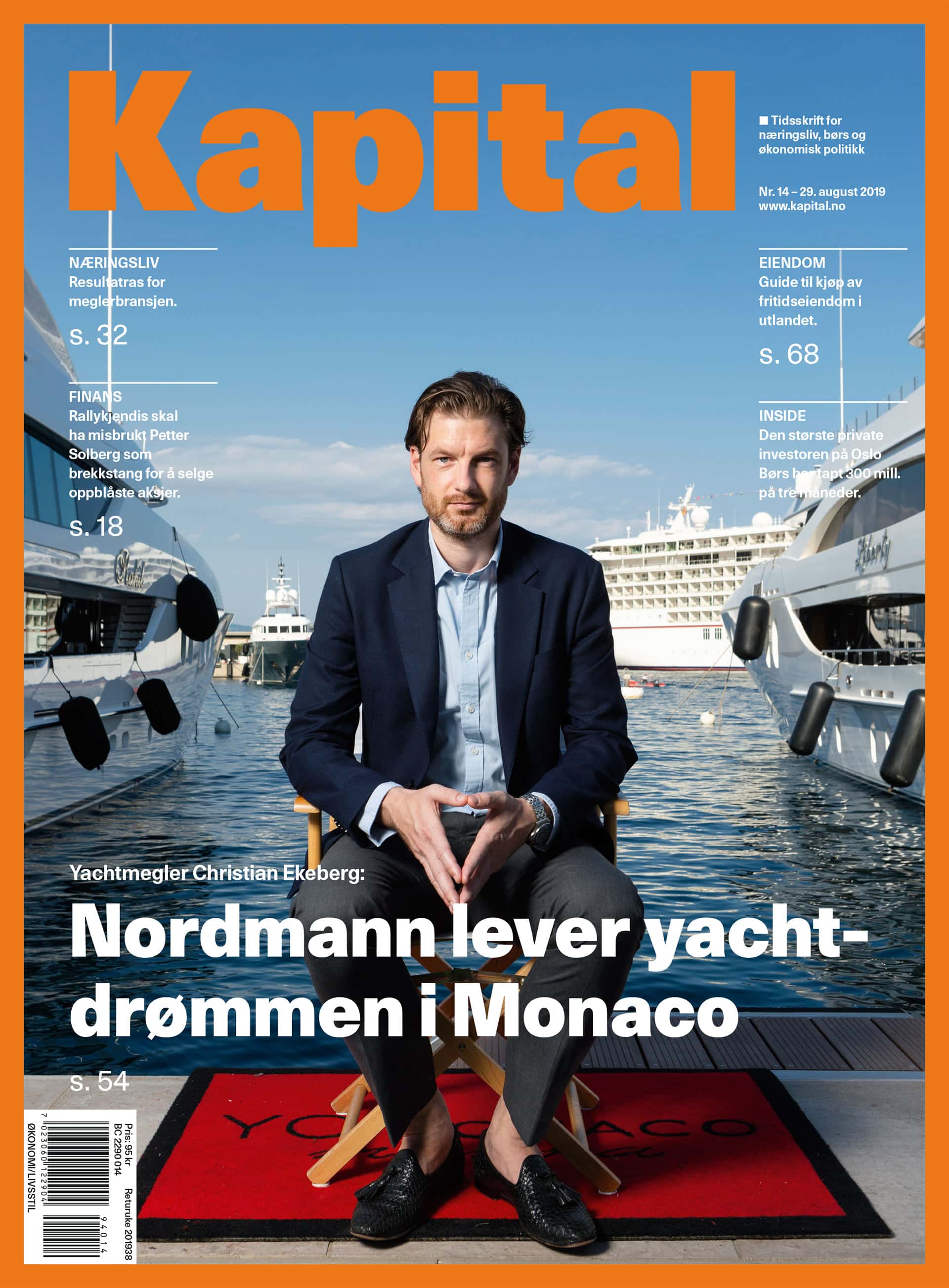 Magazine cover showing man in suit sitting in a chair on the jetty in a port