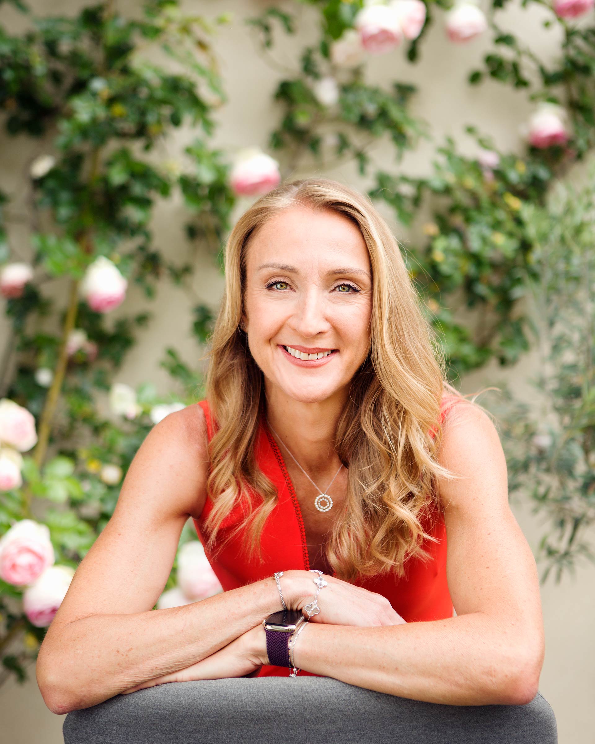Photograph of Paula Radcliffe wearing a red dress in her garden