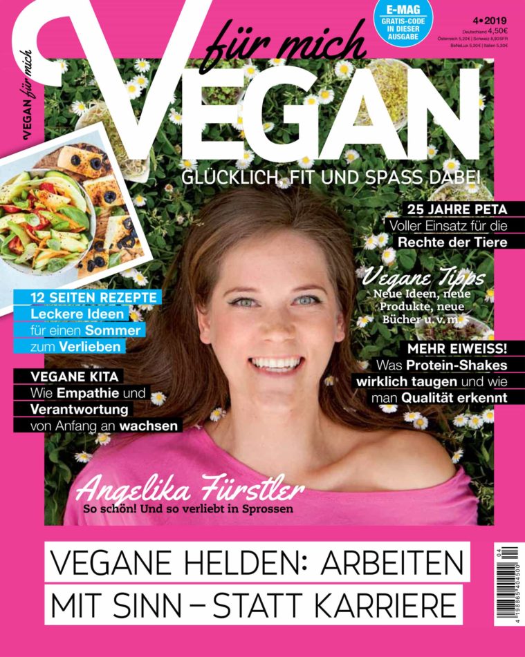 Magazine cover showing a portrait of a young woman smiling lying in grass