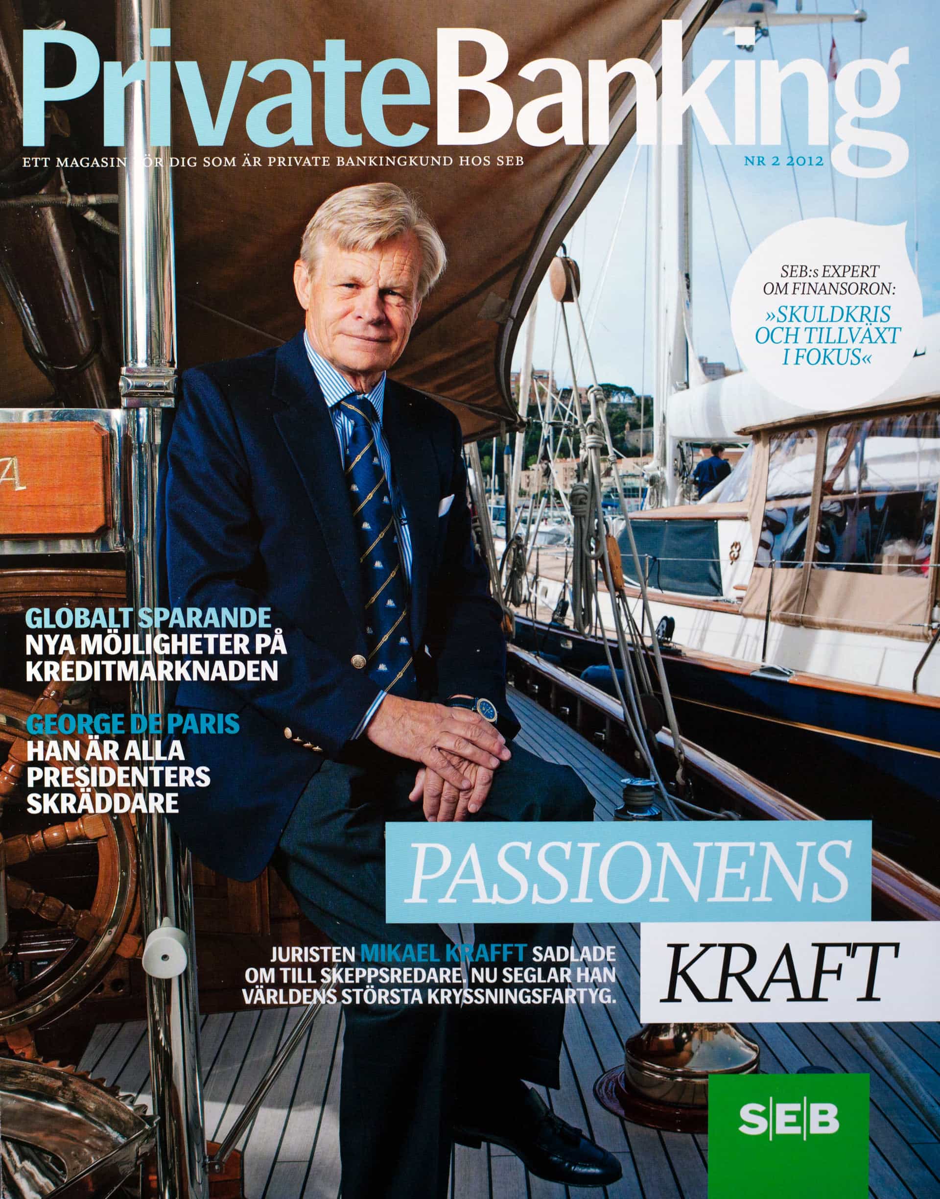 Magazine cover showing a man in suit and tie sitting on the deck of a sailing yacht in harbour