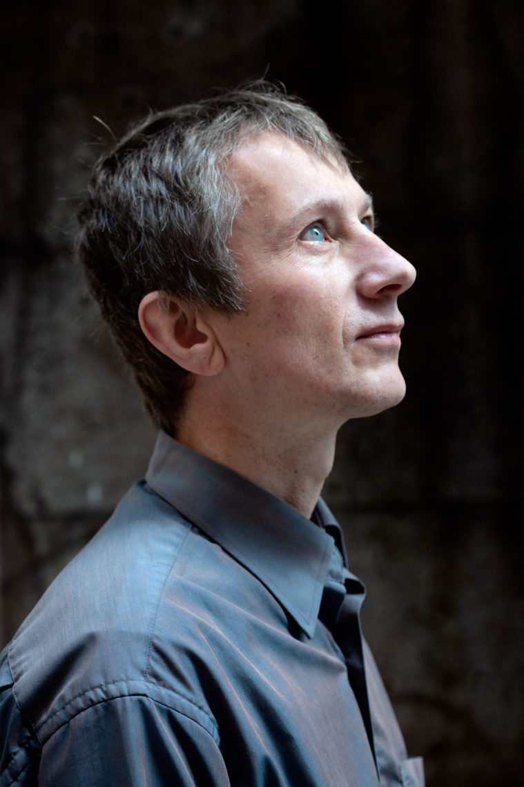 A blue-eyed man looking up, in profile