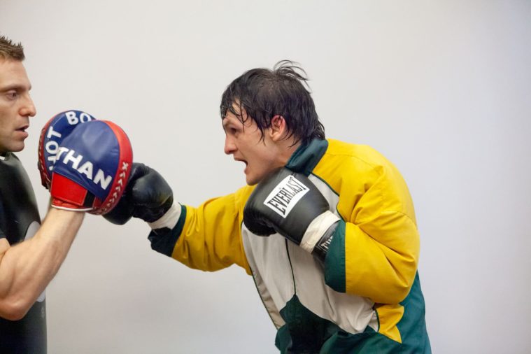 Boxer throwing a punch in profile