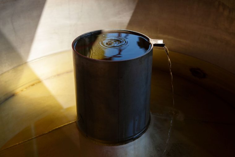 Close-up photo of a lavender oil distillation tank in the sunshine