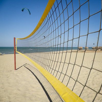 Photograph of a volleyball net on a beach