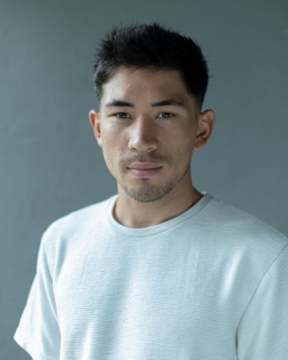 Portrait of Caleb Ewan in white T-shirt on a grey background