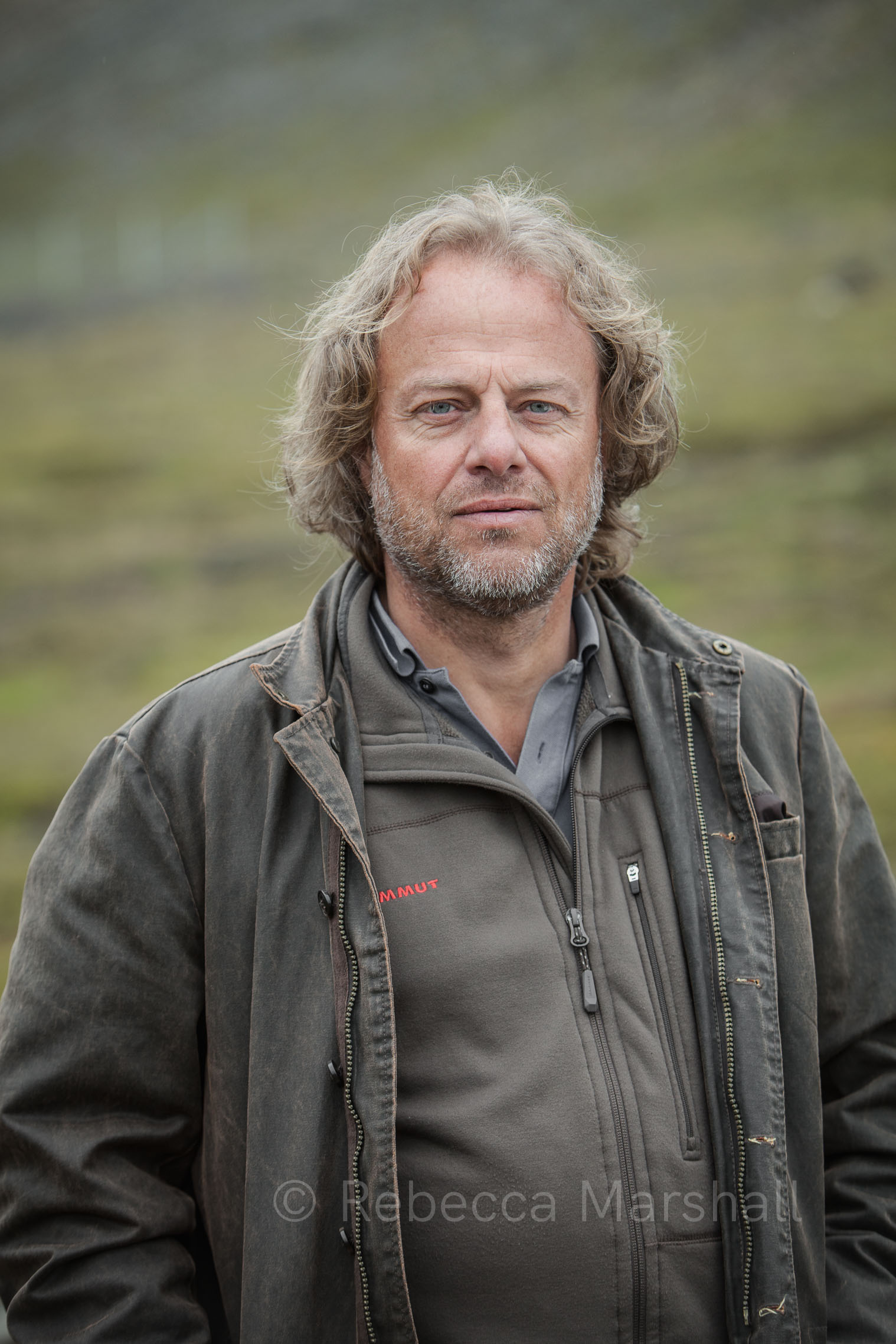 Portrait of a blond middle-aged man wearing green and brown outdoor clothing
