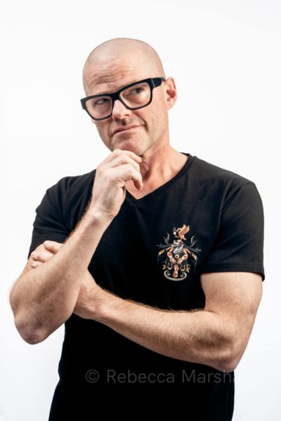 Studio portrait of Heston Blumenthal in a black t-shirt with his crest on the front
