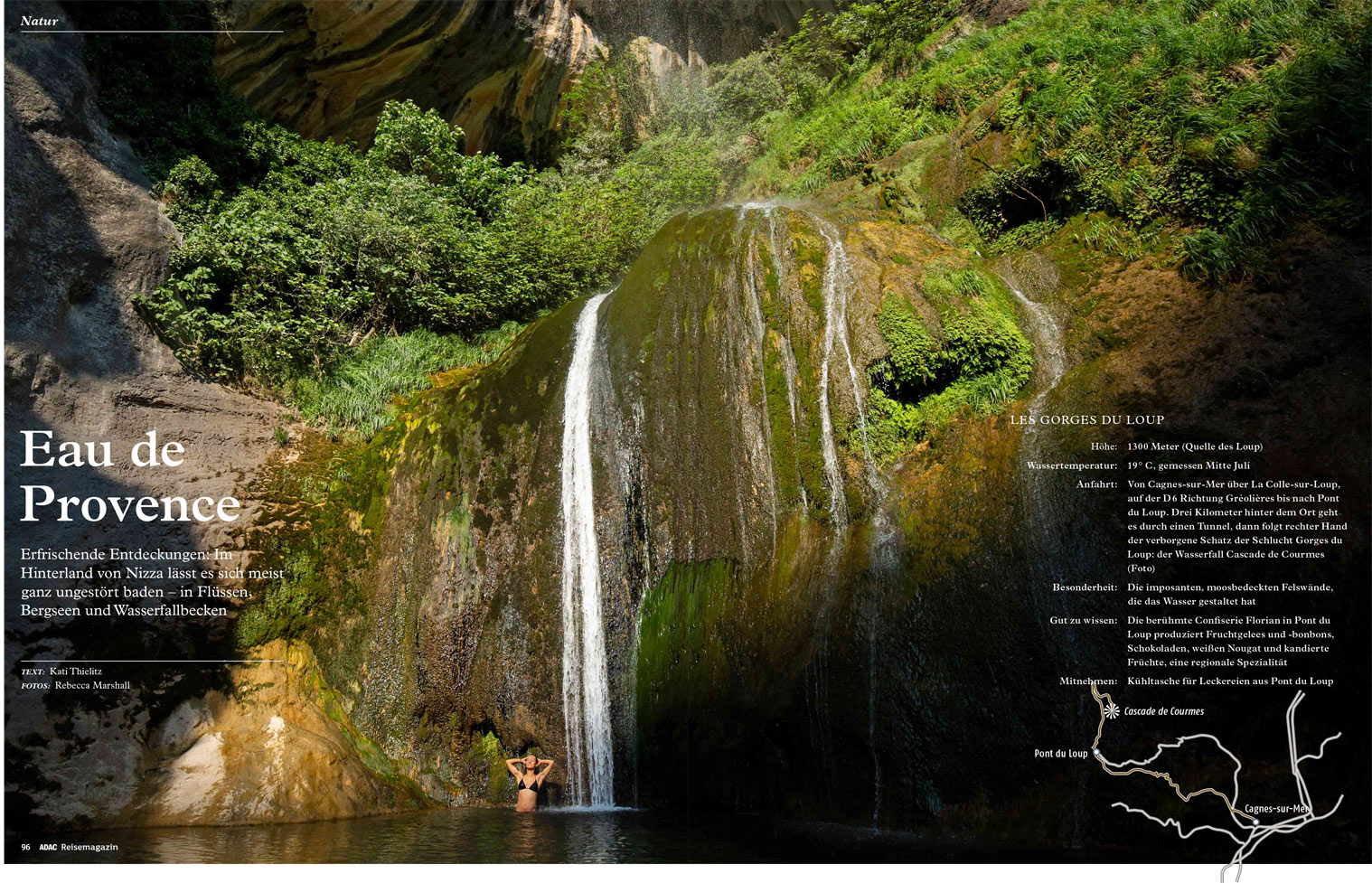 Double page magazine spread showing a full bleed photograph of a girl bathing at the foot of a waterfall
