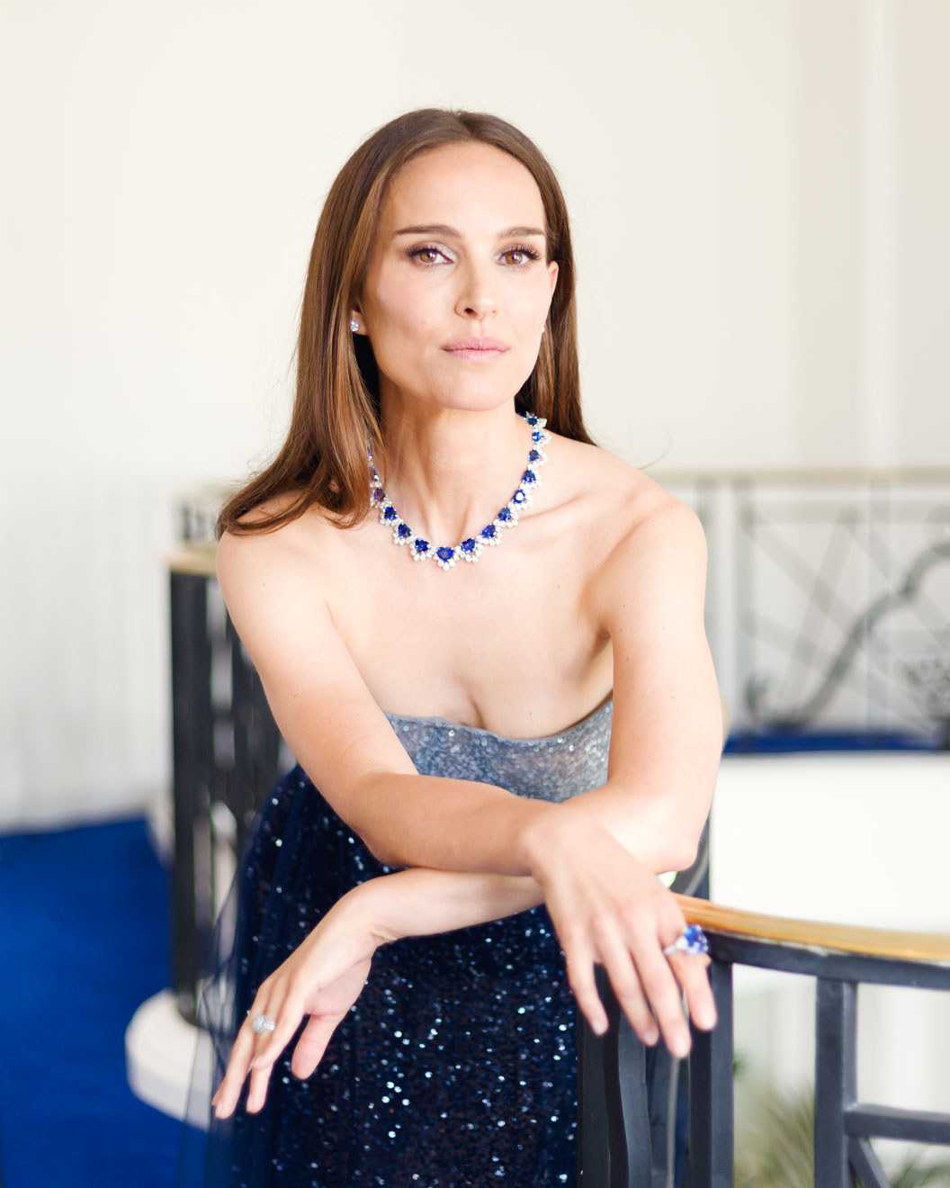 Portrait of Natalie Portman in eveningwear and blue jewellery