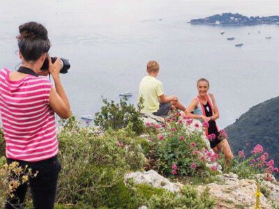 Behind the shoulder of photographer, Rebecca Marshall, who is shown making pictures of Paula Radcliffe and her son, on a cliff above the sea